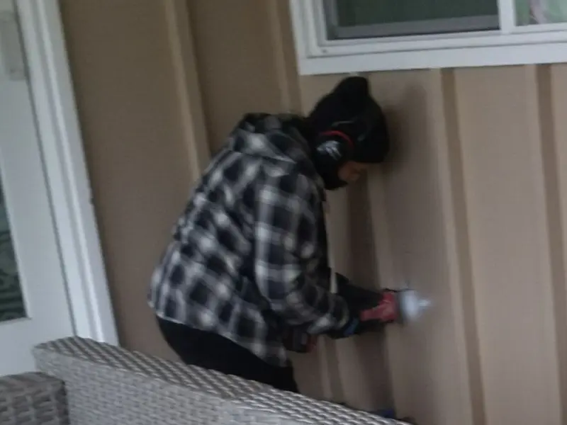 Professional electrician installing an exterior outlet in High Point